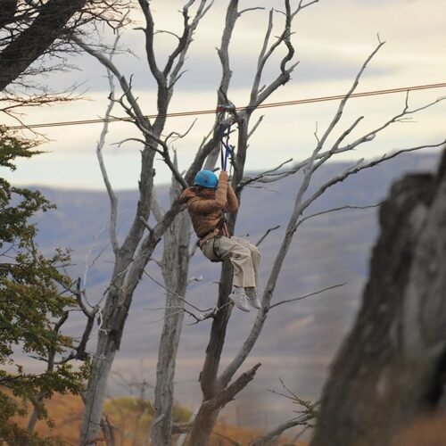 Imagen de mujer disfrutando de uno de los cuatro tramos de tirolesa en Cerro Frías